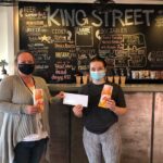 Women holding cheque at King Street Beer Company